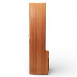 Nathan - 'Squares' corner cabinet, the upper section enclosed by two curved glazed doors with glass shelves, over a shaped base fitted with a single frieze drawer and panelled twin cupboard doors