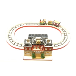 A Villeroy & Boch porcelain Christmas table decoration, modelled as a railway station with track, engines and carriages.