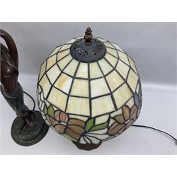 Tiffany style lamp in the form of a semi nude woman holding up a leaded lampshade together with a similar table lamp