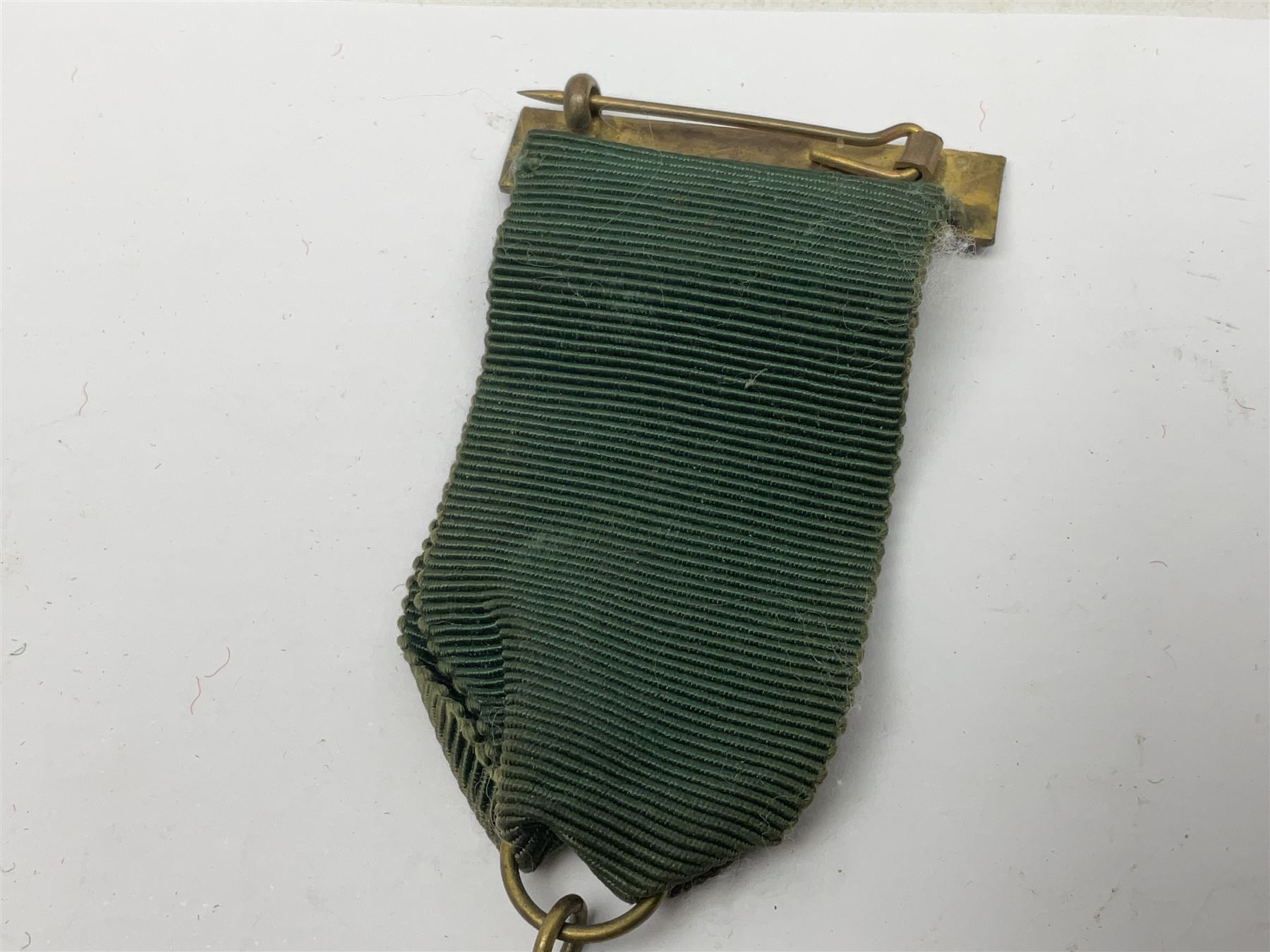 Made-up group of three WWI medals comprising 1914 Star awarded to 23598 Gnr. F. Jefferson R.G.A., British War Medal and Victory Medal with names removed; with ribbons on wearing bar; 1942 Motorist's Medal and small quantity of cap badges, Royalty badges etc