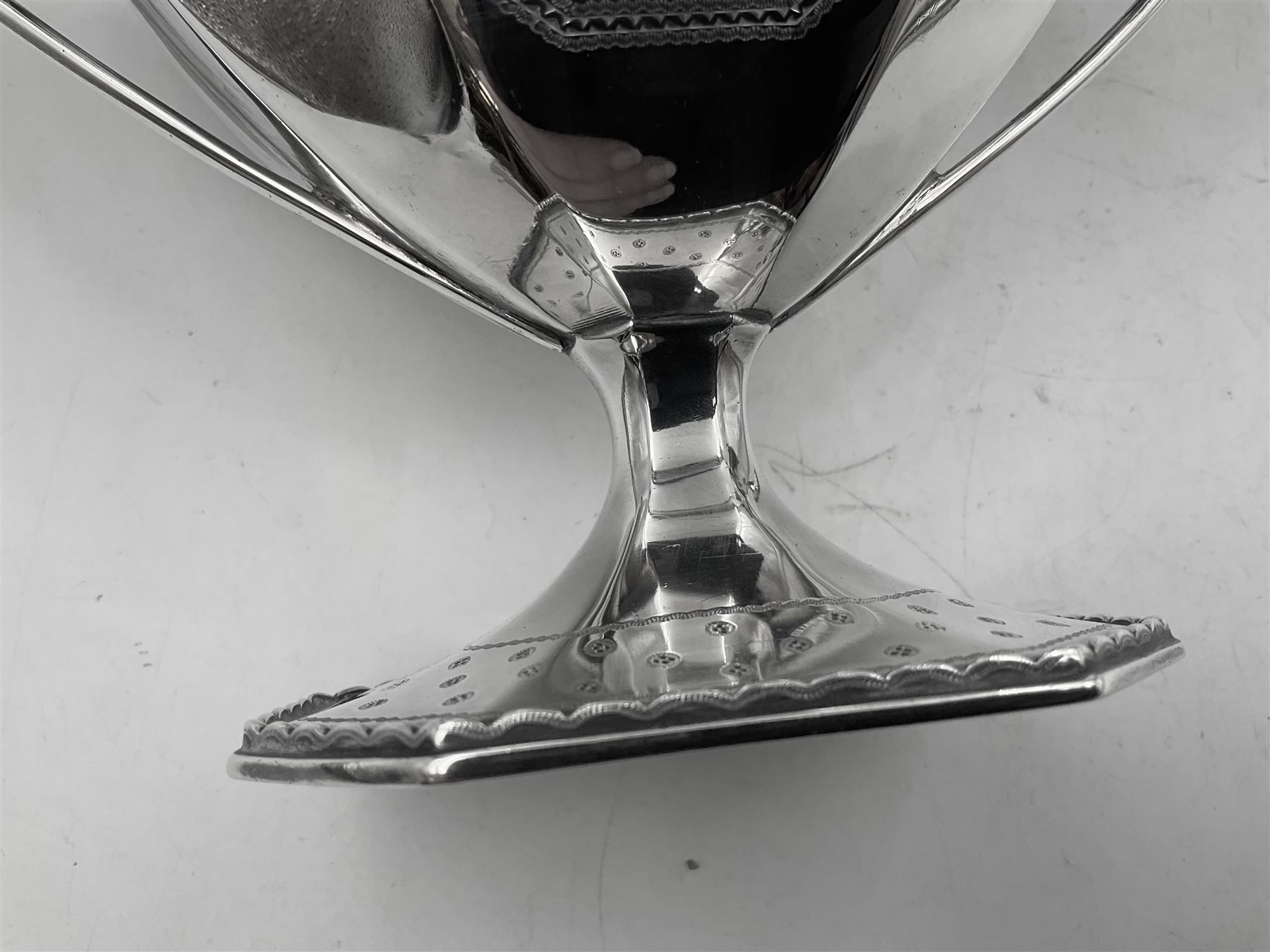 Victorian silver four piece tea service, comprising teapot, teapot stand, twin handled open sucrier and milk jug, each of octagonal form with foliate bud border and engraved decoration including crest to canted panels, and vacant panels, the teapot with ivory finial to the hinged cover and later wooden handle, hallmarked Edward Barnard & Sons Ltd, London1896, teapot including finial H15cm, milk jug including handle H16cm, teapot stand W11.5cm

This item has been registered for sale under Section 10 of the APHA Ivory Act