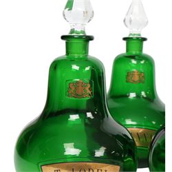 Set of four 20th century Royal Pharmaceutical Society green glass bottles, of bellied form with clear cut glass spire stopper, each body bearing gilt label in Latin: Tr.OPii., Tr.COCCi., Tr.CANNAB., and Tr.LOBEL., and gilt Royal Pharmaceutical Society crest to neck, H25cm

Provenance: From the collection of the family of Peter Green, a practising pharmacist whose career spanned the mid to late 20th century. During his professional life he managed pharmacies in Yeovil, Somerset, and later Selles Chemist in Filey, North Yorkshire, before purchasing and running his own business, Peter Green Pharmacy, located in the Market Place, Malton. The bottles were displayed as part of the traditional shop fittings in both the Filey and Malton pharmacies and were retained as part of his collection.