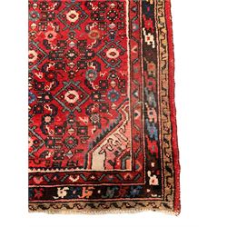 Persian crimson ground runner, the field decorated with Herati motifs,  three-band border, the main band decorated with repeating flowerheads 