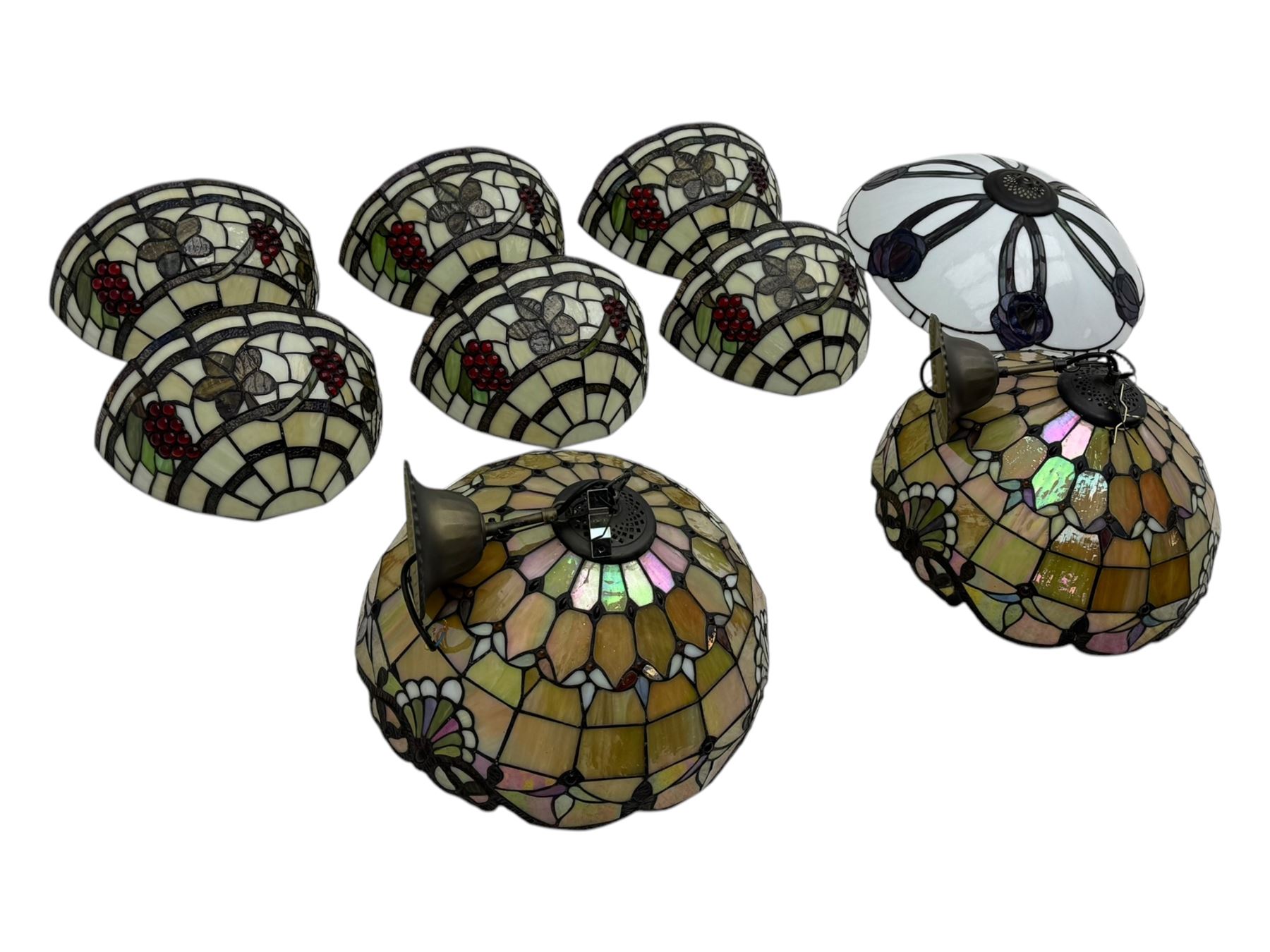 Collection of Tiffany-style light shades, to include six bowl-shaped wall-mounted fittings with floral and berry motifs and three ceiling-mounted light shades