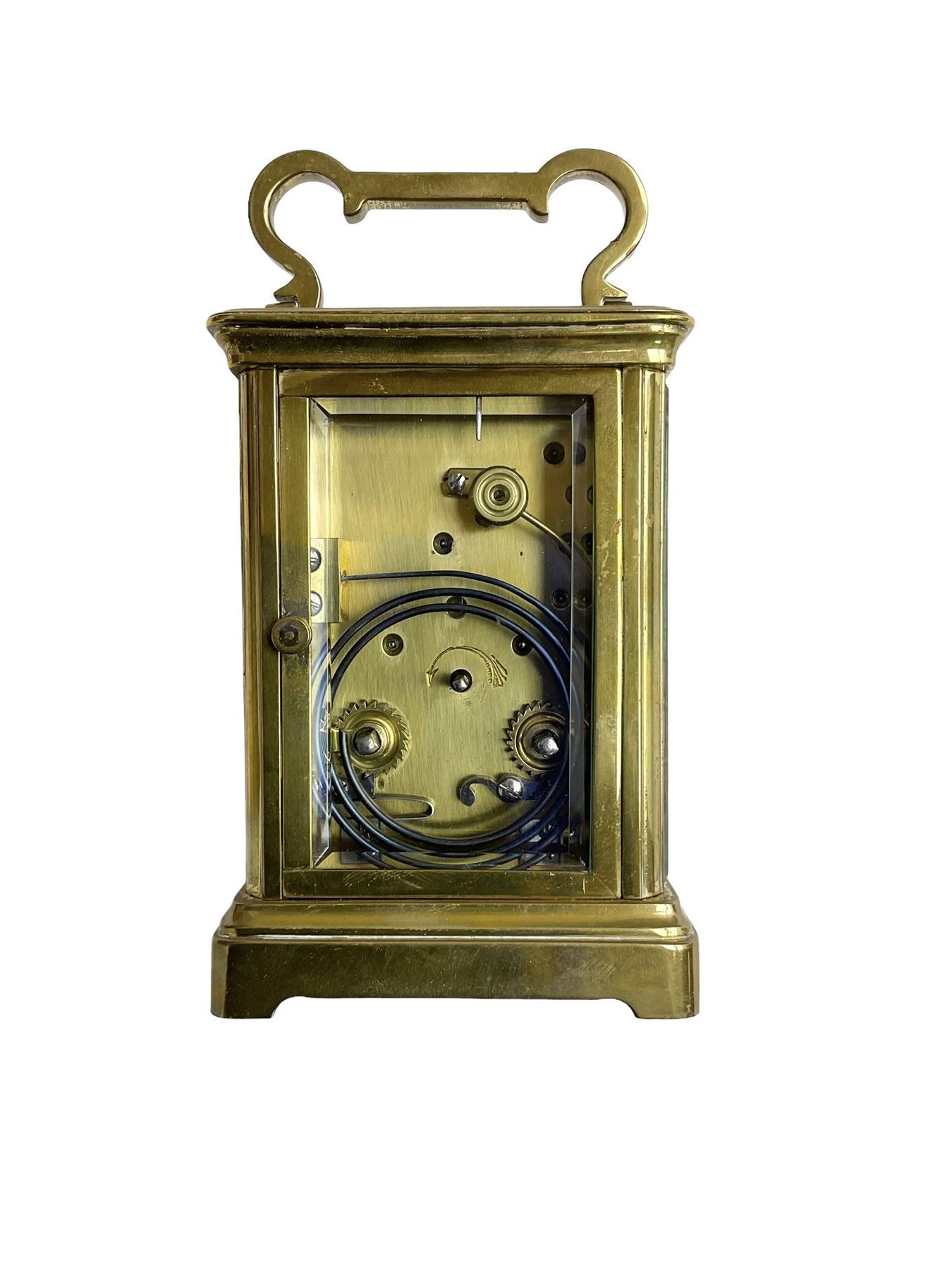 W.R. Cullen, London Street. Norwich. - 8-day French carriage clock c1900, in a corniche case with carrying handle and four bevelled glass panels, white enamel dial with Roman numerals, minute markers and spade hands, with a lever platform escapement and rack striking movement striking the hours and half hours on a coiled gong. 