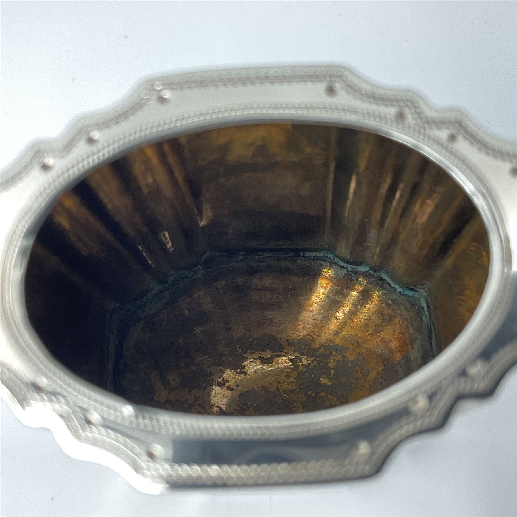 Victorian three-piece silver tea service, comprising teapot, twin handled open sucrier and milk jug, of oval form with shaped rim and C handles, each engraved with crests and bands of strapwork decoration, the milk jug and sucrier with gilt interiors, hallmarked Josiah Williams & Co, Exeter 1881, the teapot with ivory insulators and finial, all contained with a tooled leather, blue silk and velvet lined fitted case, retailed by West & Sun, Dublin 
This item has been registered for sale under Section 10 of the APHA Ivory Act