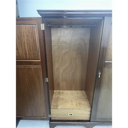 Wylie & Lochhead, Glasgow - early 20th century mahogany and satinwood double wardrobe, projecting cornice over panelled doors, interior fitted with mirrored door, shelves, drawers, hooks and hanging rail, raised on bracket supports with ceramic castors