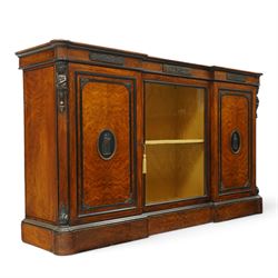 Lamb of Manchester (est. 1843) - Victorian Aesthetic Movement inlaid figured and burr walnut inverted-breakfront credenza, the shaped rectangular top with ebony banding and boxwood stringing, the frieze applied with bronze mounts decorated with foliate and scroll motifs, fitted with central glazed door flanked by panelled doors with central oval metal plaques depicting Classical Muses with lyre, the flanking canted uprights applied with caryatid maidens holding torches, acanthus terminal over skirted base