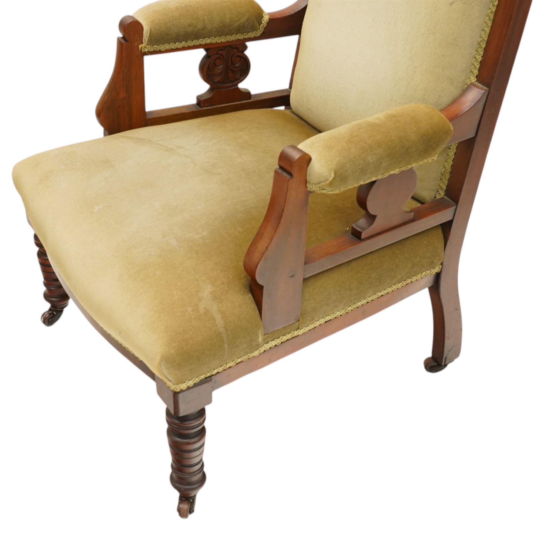 Pair of late Victorian mahogany carved open armchairs, with carved cresting rail, above upholstered seat, back and arms, raised on turned supports terminating in castors