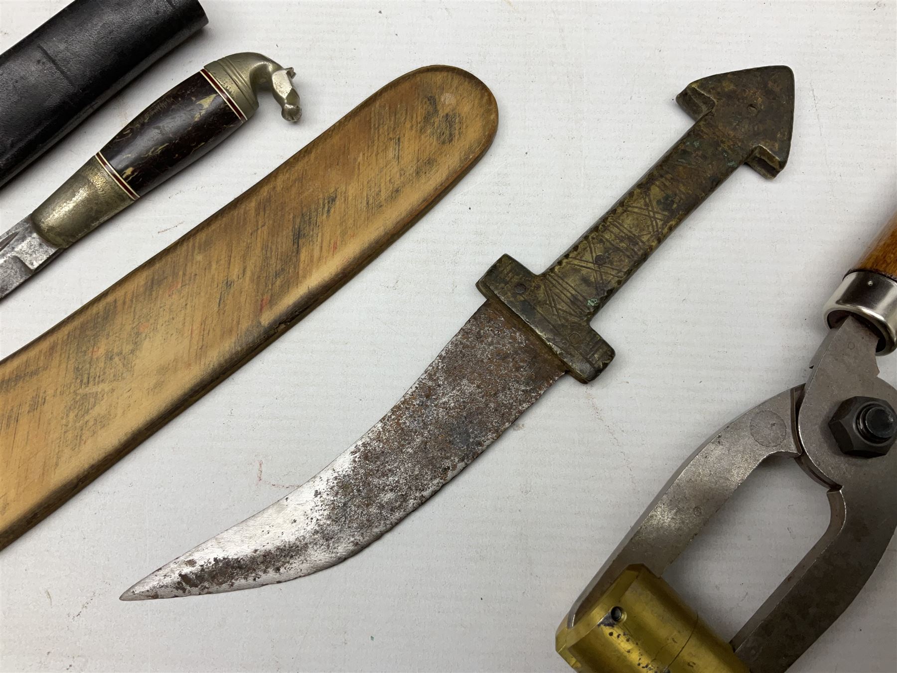 Assorted militaria including ten leather or canvas cartridge and other belts, maroon beret with 17th Lancers cap badge, modern bullet mould, leather and brass shot flask, two knives, shell cases, boomerang etc; in tin deed box