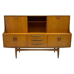 G-Plan teak sideboard, the top section with sliding door and fall front compartment, the lower section with two double cupboards and three drawers
