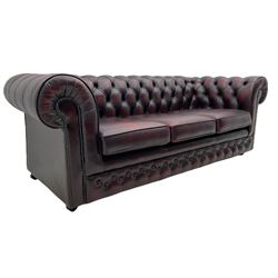Chesterfield three seat sofa, upholstered in deeply buttoned oxblood leather