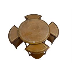 Yew wood circular coffee table with four nesting tables, inset leather and glass tops, on turned and fluted supports