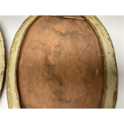 Pair of 19th century classical terracotta relief wall plaques depicting the goddess Hygeia and another goddess, seated holding an ewer, each of oval form, indistinctly signed, each stamped Ferreira verso, H42cm, W30cm