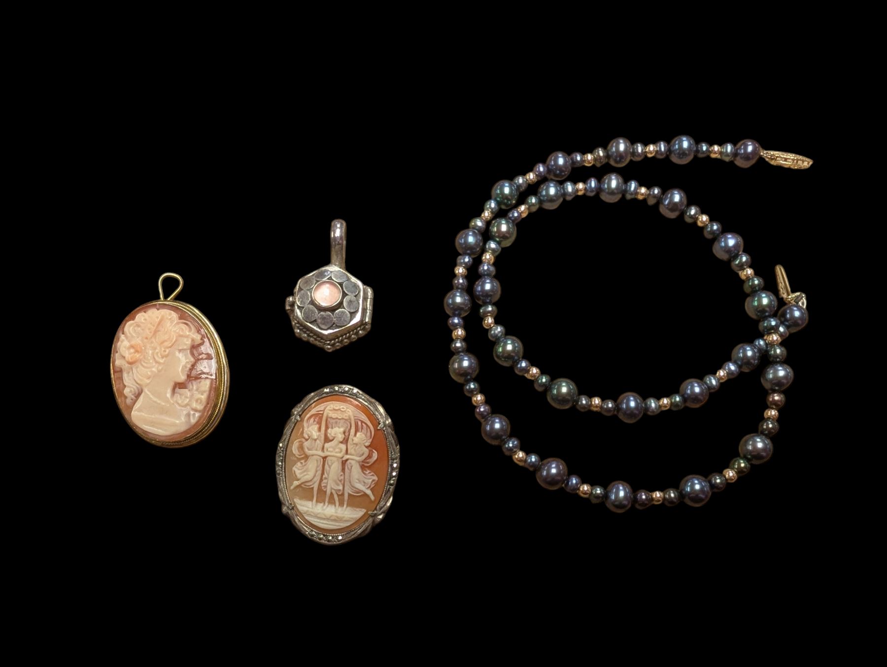Beaded necklace with a 10ct gold clasp, two silver cameo brooches, and a silver trinket pendant