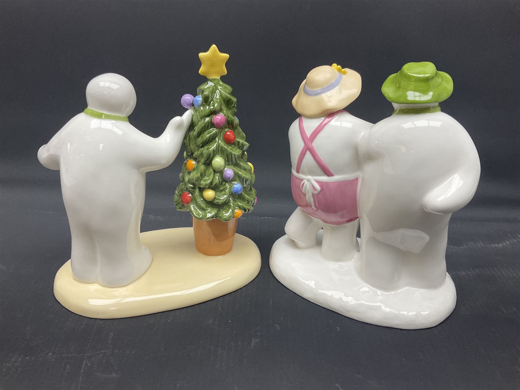 Four Coalport Characters The Snowman figures, comprising Snowman's Surprise, Christmas Cheer with certificate, The Bashful Blush and Dancing at the Party, all with original boxes 