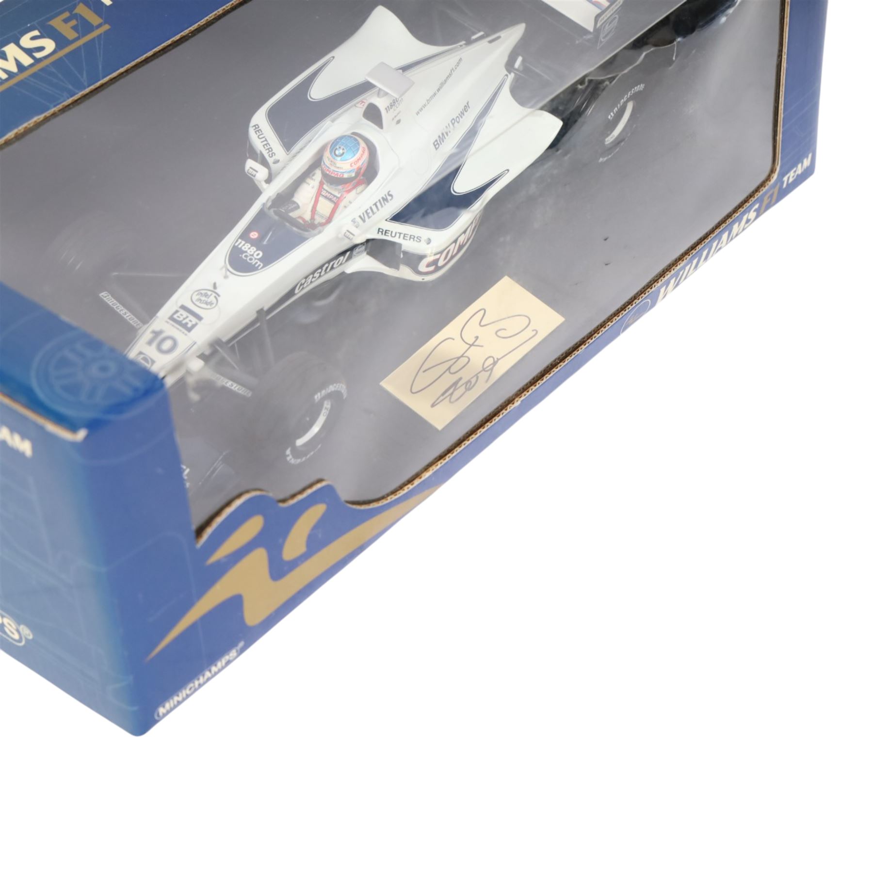 Three signed limited edition 1:18 scale Formula One models, comprising Hot Wheels Jordan EJ12 signed by Takuma Sato, Hot Wheels Jaguar Racing R2 signed by Eddie Irvine and a Minichamps Williams F1 Team model signed by Jenson Button, 1:18 scale model, all boxed