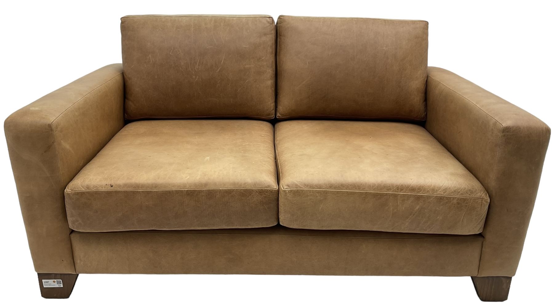 20th century two seat sofa, upholstered in tan leather with loose back