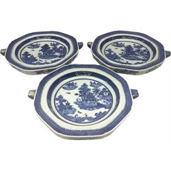 Three late 18th/early 19th century Chinese export hot water plates, of octagonal form decorated with landscape set with pagoda, islands, huts and figure crossing a bridge, within spear head and diaper borders, D23cm