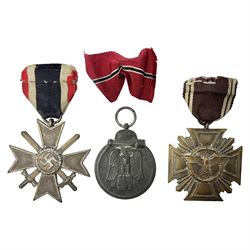 WW2 German Eastern Front Medal awarded to those who served on the German Eastern/Russian Front during the Winter Campaign period of 15th November 1941 to 15th April 1942 with original ribbon; German War Merit Cross with swords; and NSDAP Long Service Award (3)
