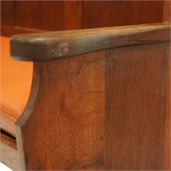 Sid Pollard of Thirsk – late 20th century adzed oak settle, tall panelled back with projecting top rail, shaped arms and tan upholstered drop-in seat, raised on chamfered end supports