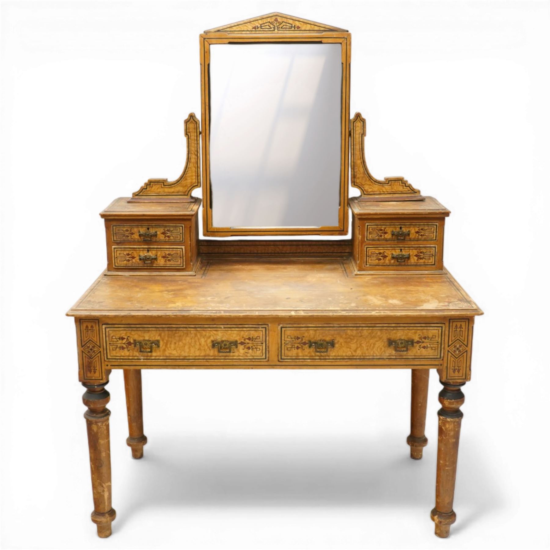 Late Victorian Aesthetic Movement scumbled and painted pine dressing table, arched swing mirror over four small trinket drawers, decorated with painted ebonised stringing and Aesthetic Movement motifs, rectangular top fitted with two drawers, on turned supports