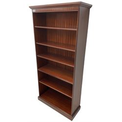 Tall mahogany open bookcase, moulded cornice over one fixed shelf and four adjustable shelves, on plinth base