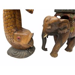 Carved wooden stand in the form of a fish H51.5cm and a carved wooden stand in the form of an elephant H39.5cm.