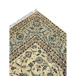 Persian Kashan carpet, light sage green ground, the field decorated all-over with interlaced foliate and plant motifs, repeating scrolled border with stylised flower head motifs