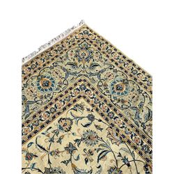 Persian Kashan carpet, light sage green ground, the field decorated all-over with interlaced foliate and plant motifs, repeating scrolled border with stylised flower head motifs