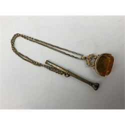 Victorian gold propelling pencil of hexagonal form decorated with foliate engraving and stone set shield shaped capital terminal, with attached gold chain and fob seal (pencil tested to 7.4ct, fob seal attachment tested to 9.7ct and stamped 9ct, chain tested to 5ct)