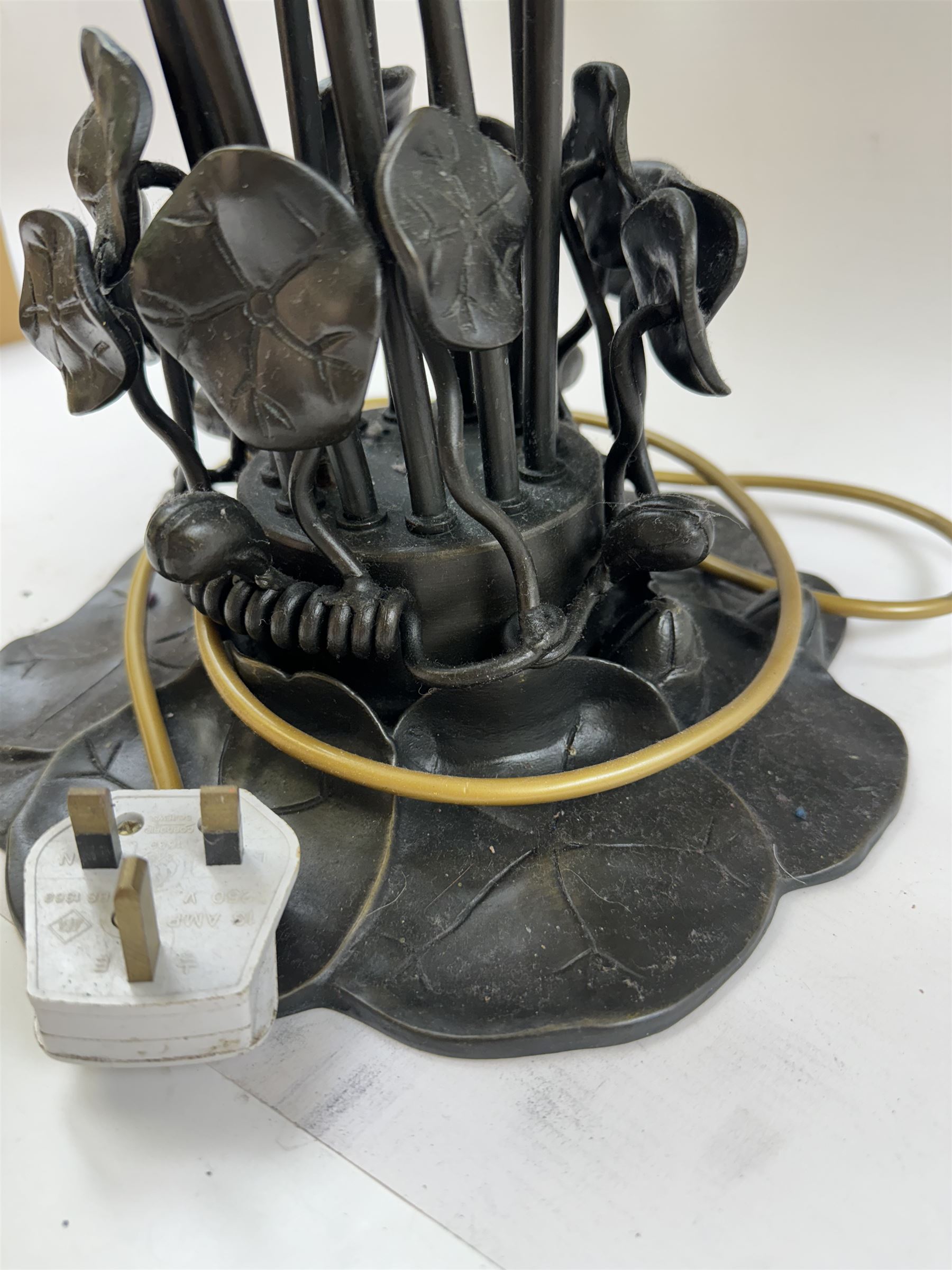 Art Nouveau Tiffany style table lamp, the bronzed base modelled as lily pads leading to tendrils and twelve branches supporting green and yellow glass lily flower shades, H53cm