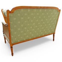 French Empire design varnished wood three piece lounge suite comprising of two cane armchairs and matching sofa, carved top rails with foliate terminals, cane side panels and padded scroll arms, upholstered in a green brocade with matching piping, on fluted legs