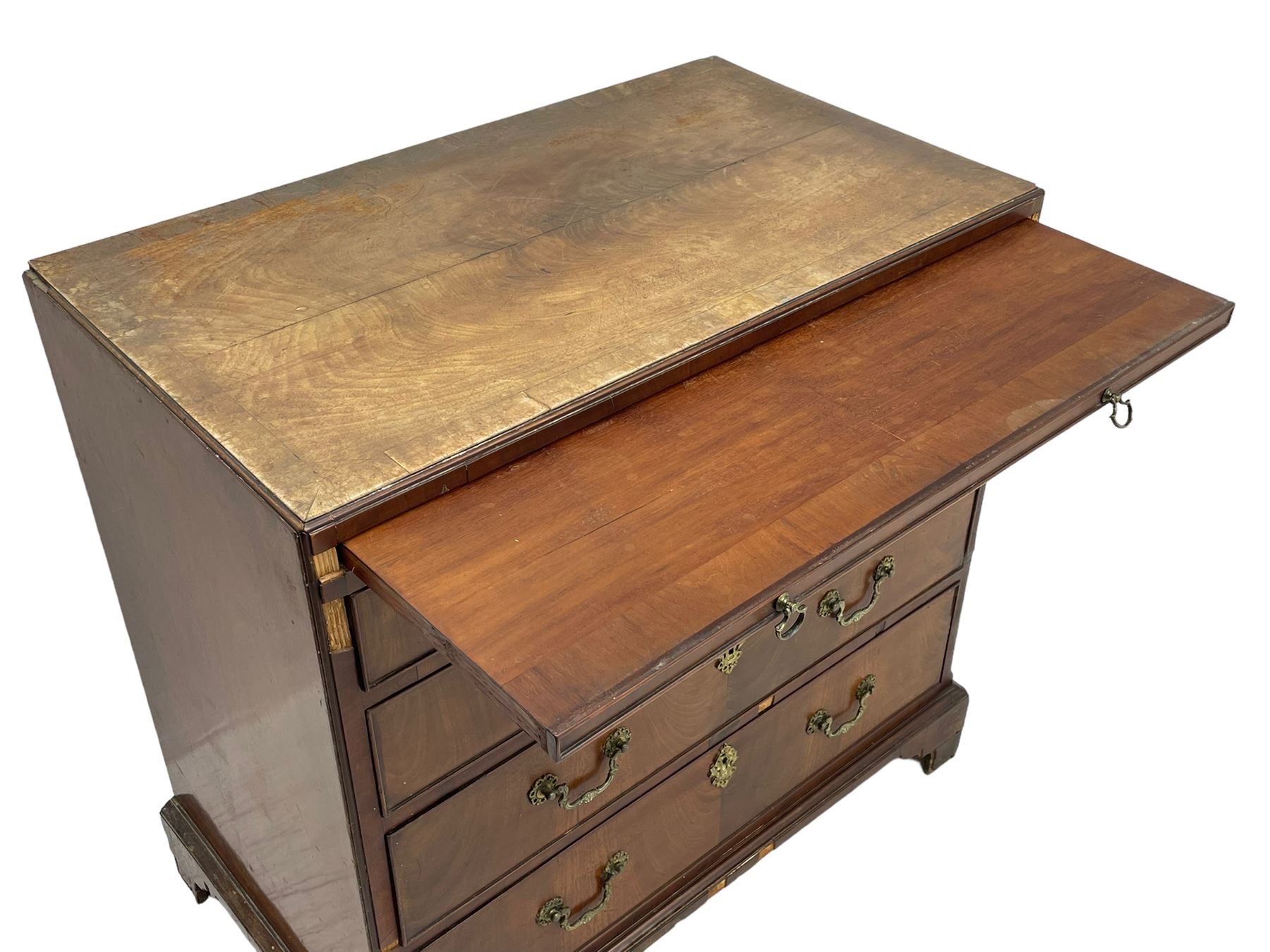 George III mahogany chest, banded caddy top with moulded edge, brushing slide over four graduating cock-beaded drawers, ornate cast gilt metal handle plates and escutcheons, swan neck handles cast with dolphins, shells and C-scrolls, lower moulding over bracket feet