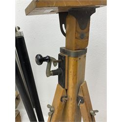 Three wooden adjustable tripods for plate cameras, together with a Linhof of Munchen metal tripod in a canvas case 