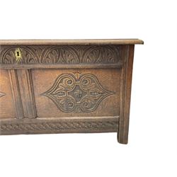 18th century oak blanket chest or coffer, rectangular hinged top with three panels and moulded edge, frieze carved with lunette and acanthus leaf decoration, two front panels carved with scrolling motif, raised on stile supports