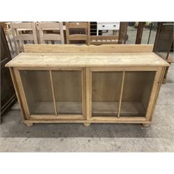19th century pine cabinet, raised shaped back over rectangular top, enclosed by two sliding glazed doors, on turned feet - THIS LOT IS TO BE COLLECTED BY APPOINTMENT FROM THE OLD BUFFER DEPOT, MELBOURNE PLACE, SOWERBY, THIRSK, YO7 1QY