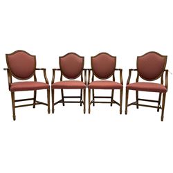 Set of six Hepplewhite design mahogany dining carver chairs, shield back within moulded frame, upholstered in pale red fabric decorated with fleur-de-lis motifs, on moulded square tapering supports with spade feet, united by plain stretchers 