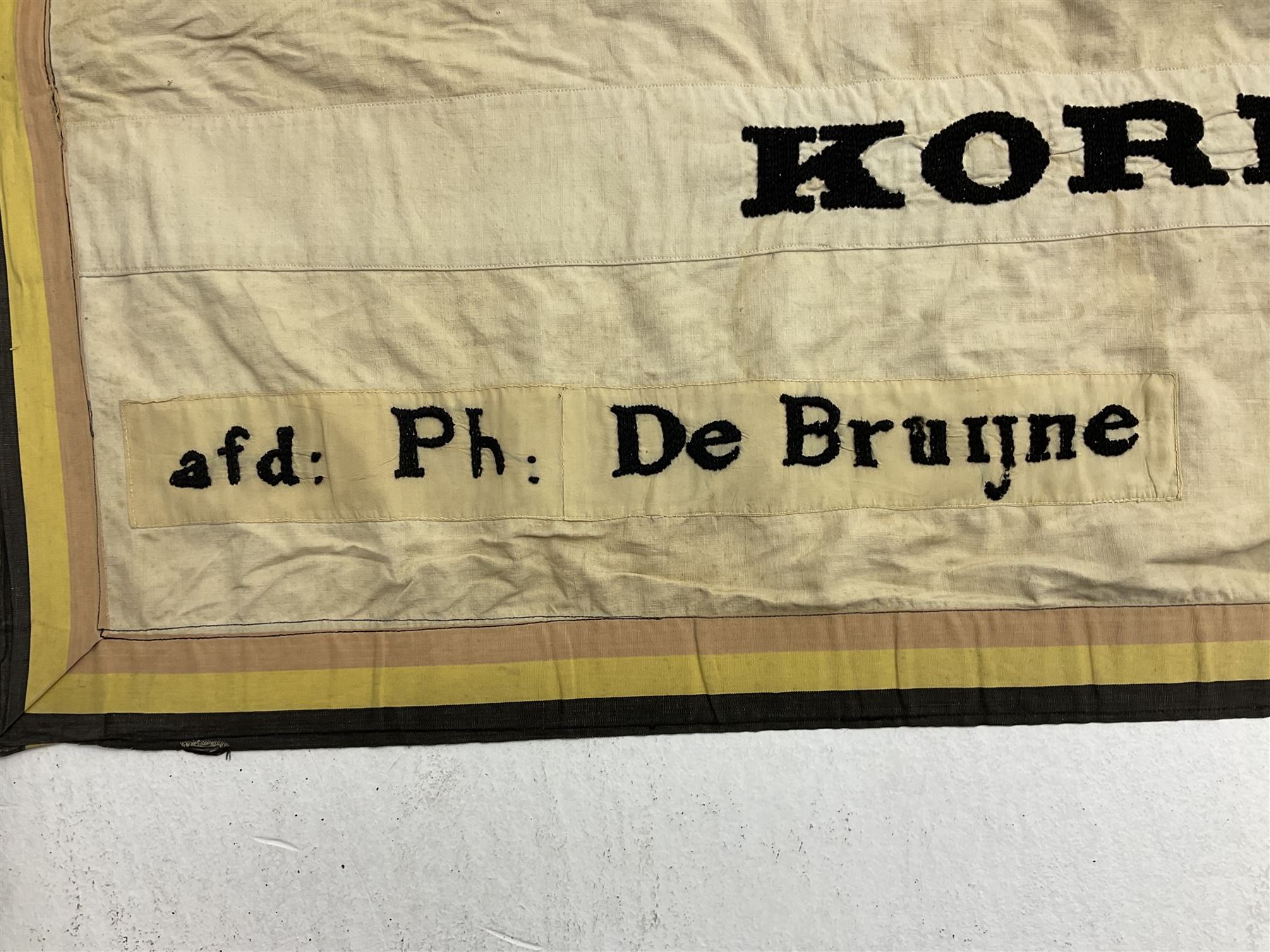 WW2 Belgian Partisan/Resistance two-sided banner embroidered in black on a cream ground 'Belgische Partisanen Korps 032 afd: Ph: De Bruyne' within a Belgian flag border; on wooden pole with gilded metal lion and laurel wreath finial