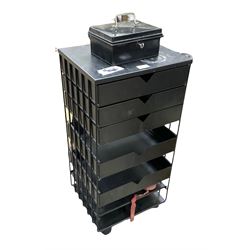 Black metal drawers on castors and small metal box with key