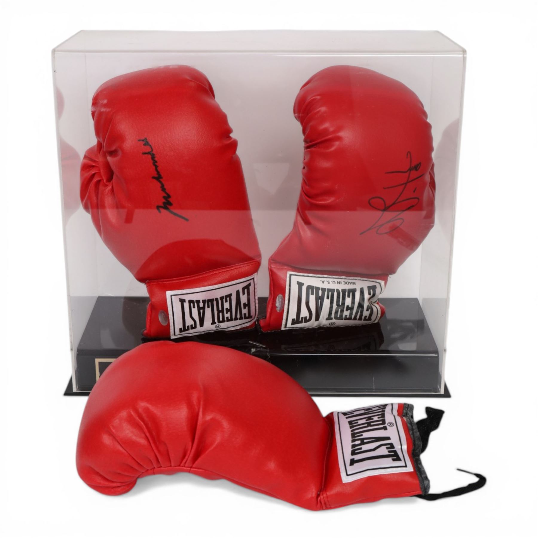 Muhammad Ali and George Foreman signed boxing gloves, two Everlast gloves the left hand glove signed by Ali and right signed by Foreman, both in black marker pen, in Perspex display case with plaque to base displayed with a further unsigned glove, each with Mounted Memories holographic stickers, case H36cm