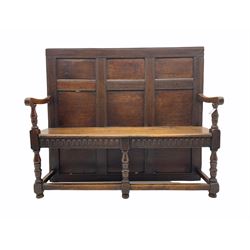 George III oak panelled back settle, the arms with scroll carved terminals on turned supports, arcade carved frieze and return rails, joined by plain stretchers