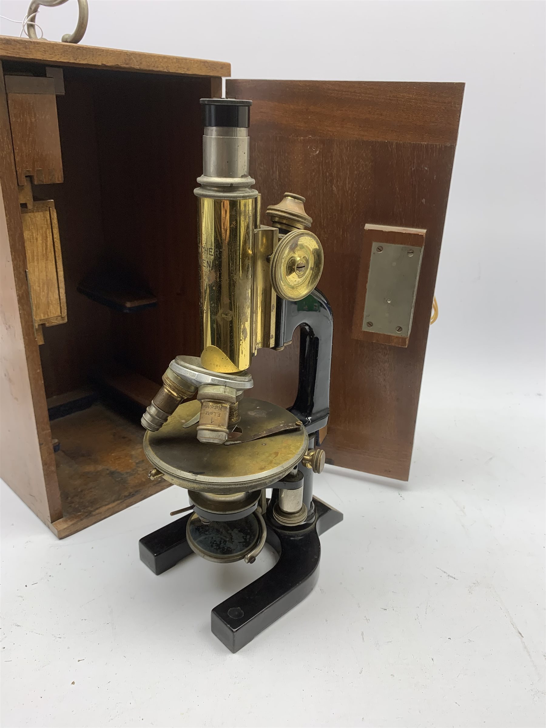  Reichert Wien Late 19th century brass and black japanned monocular microscope stamped C.Reichert Wien, No.48054, coarse and fine adjust, circular stage on horseshoe base, with three ocular and five objective lenses, in fitted mahogany case   