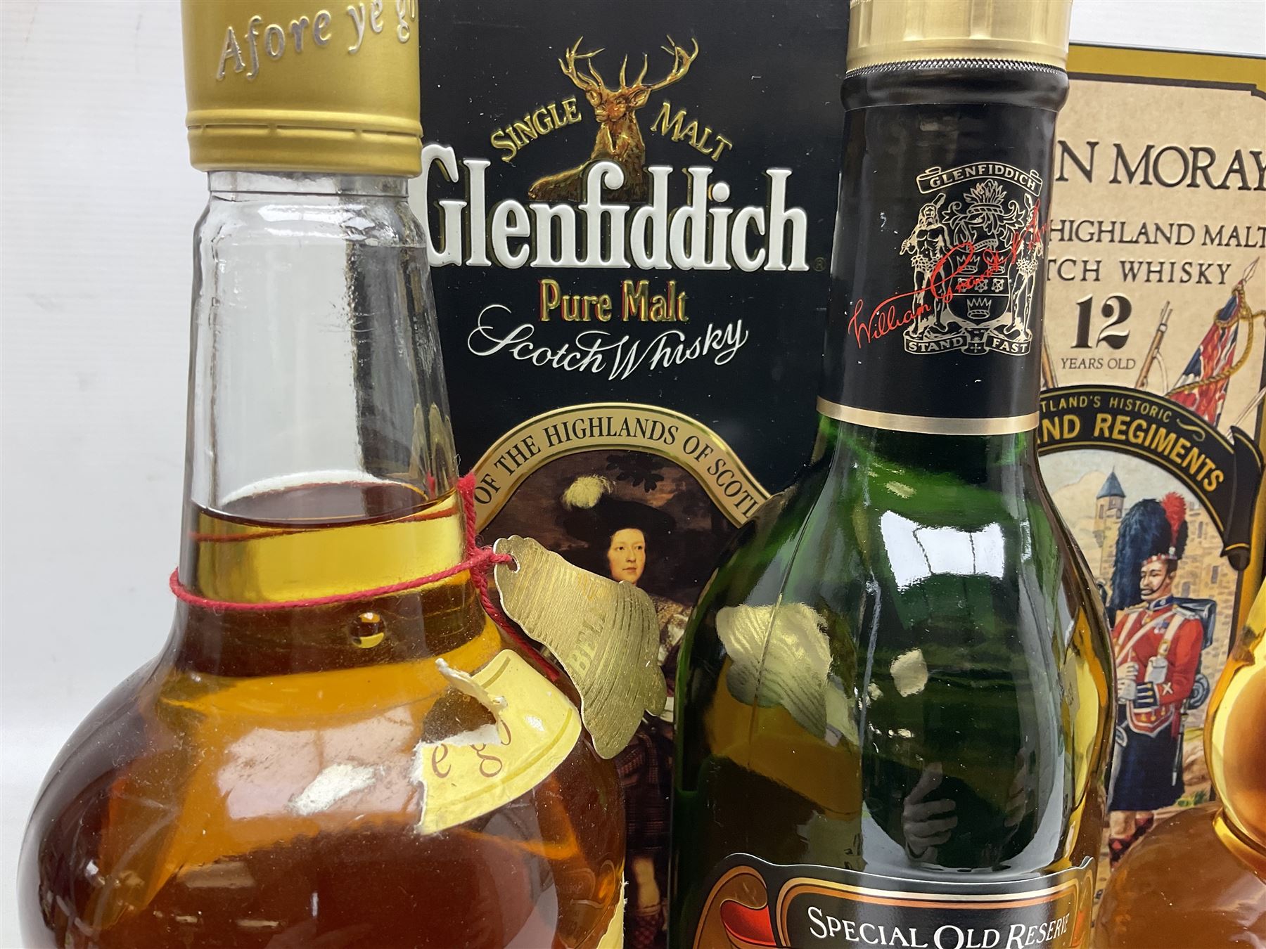 Glen Moray 12 Year Single Malt Highland Scotch Whisky, 70cl 40% vol, one bottle, in Highland Regiments The Black Watch presentation tin, Glenfiddich Pure Malt Scotch Whisky, Special Old Reserve, 70cl 40% vol, one bottle, in Clan Murray presentation tin, Bell's Extra Special Old Scotch Whisky, Aged 8 Years, 70cl 40% vol, one bottle, in box and Bell's Extra Special Old Scotch Whisky, 1l, 43% vol (4)