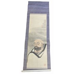 Japanese painted hanging scroll, decorated with a head and shoulder portrait of a sage, and further detailed with seals and characters