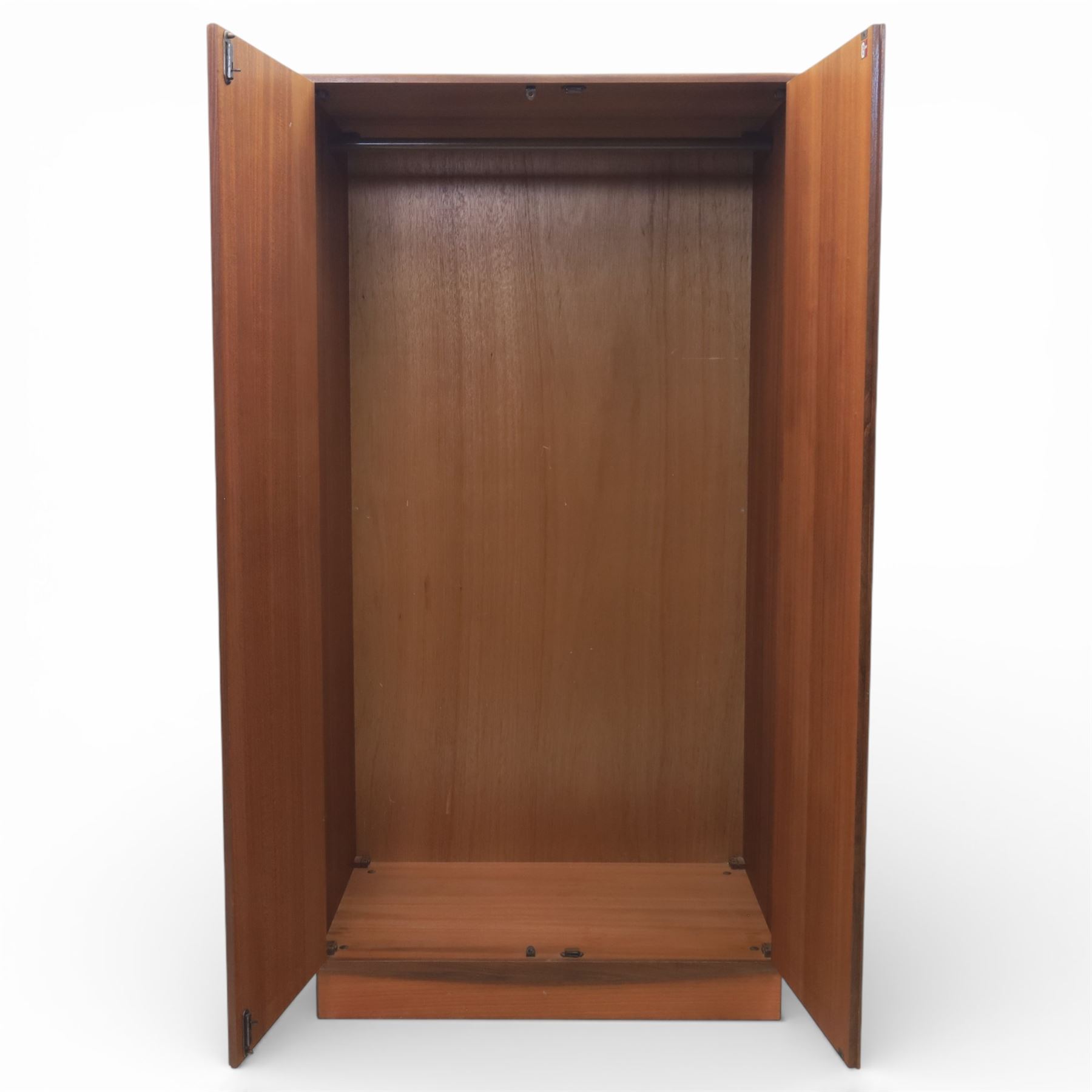 G Plan - 'Fresco' teak double wardrobe, twin doors enclosing a single clothes rail, on a recessed plinth base with castors beneath  