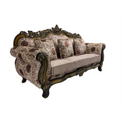 Italian Baroque design three seat sofa, hardwood framed, the cresting rail carved and pierced with c-scrolls and flower heads, scrolled arms, upholstered in floral patterned and striped fabric, with scatter cushions 