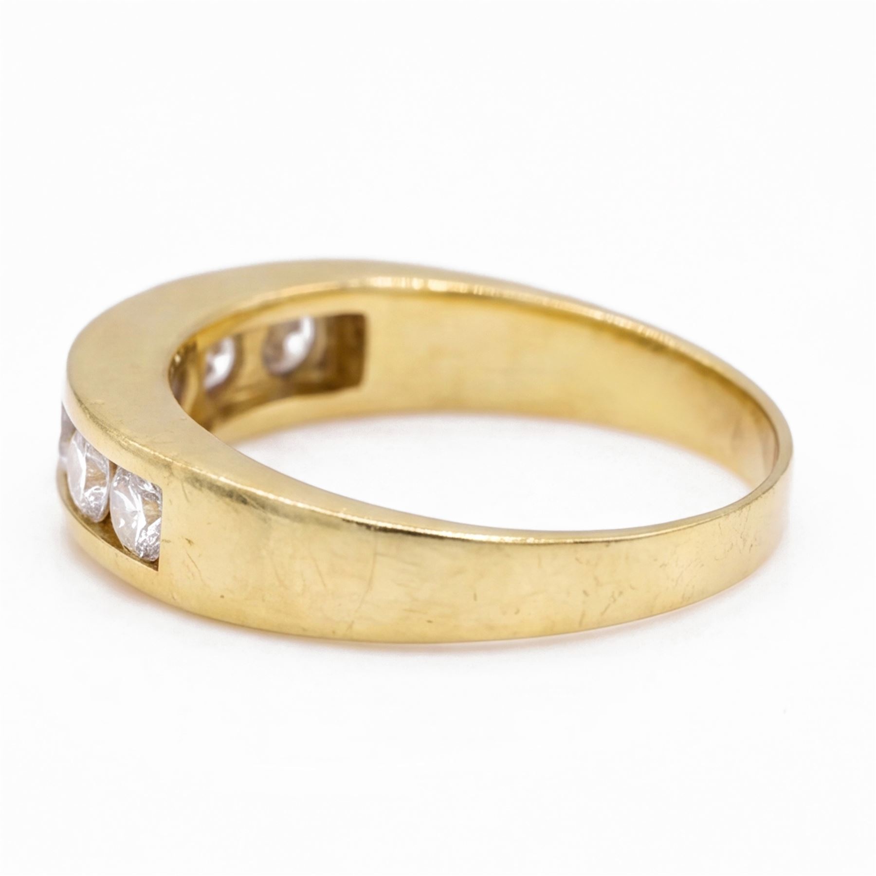 18ct gold diamond ring, channel set with seven round brilliant cut diamonds, hallmarked, total diamond weight 0.75 carat