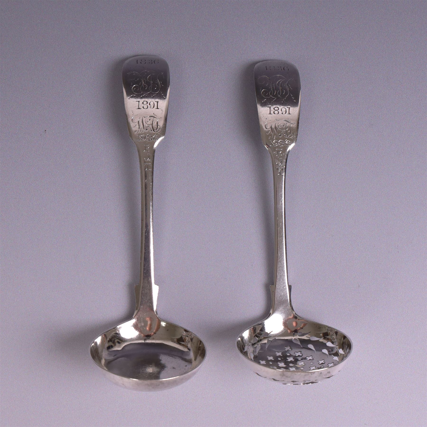 Pair of William IV silver Fiddle pattern spoons, comprising ladle and sifting spoon, each with presentation engravings to terminal, hallmarked William Rawlings Sobey, Exeter 1836
