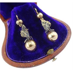 Pair of 19th / early 20th century white and yellow gold butterfly pendant  earrings, the 18ct gold butterflies suspended between two 14ct gold spheres, in fitted velvet and silk lined box